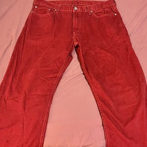 Levi men’s jeans color is a red . The material is a like a soft fabric .